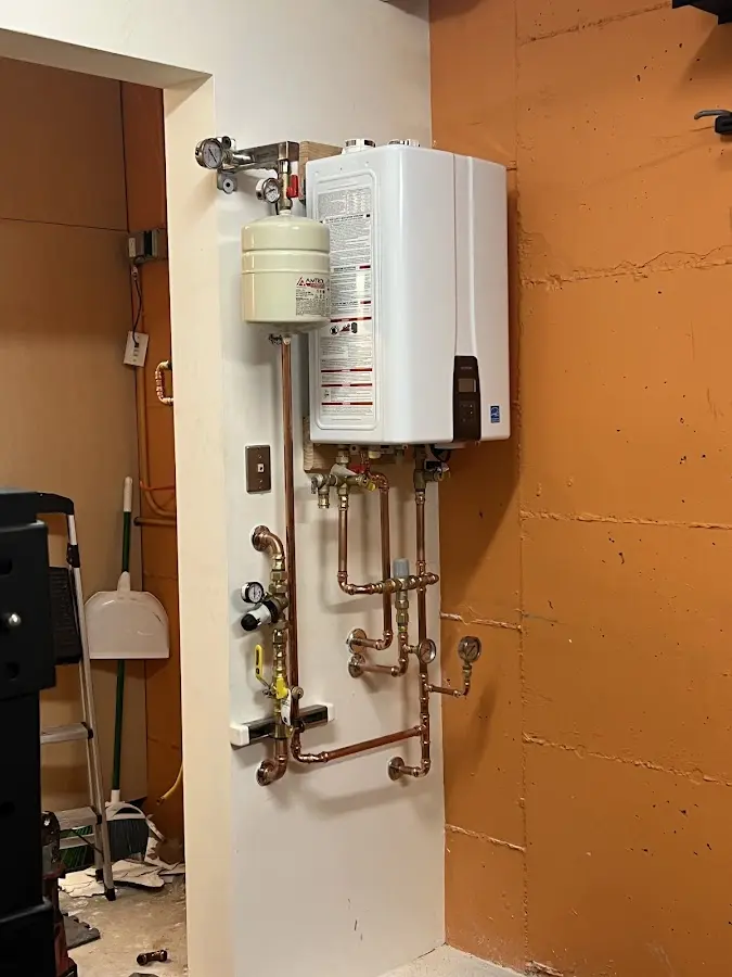 Plumbing technician inspecting water heater connections in Murrieta